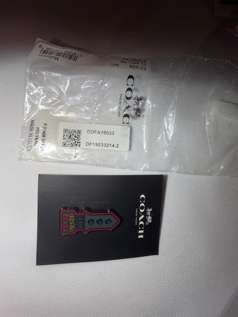 Coach Black Logo Round NYC pin and Coach Rocket pin.